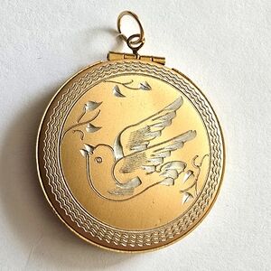 Vintage bird locket pendant gold tone with silver tone flying round